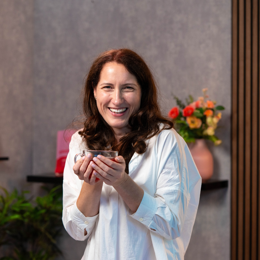 Unflavoured collagen powder being added to a women's morning drink